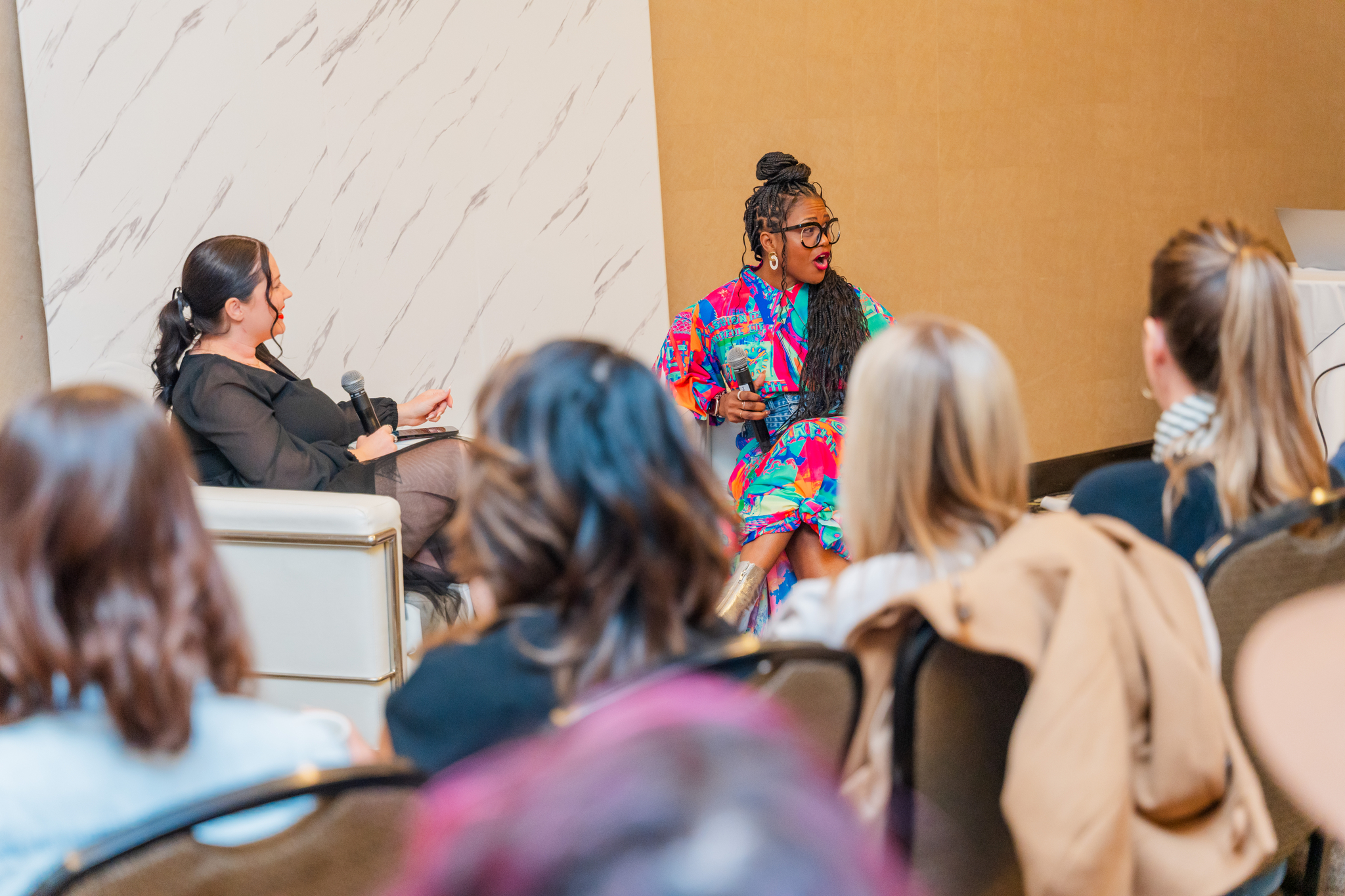 Monique Bryan on a panel speaking to a full audience